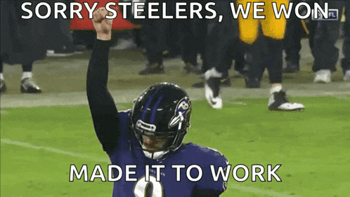 a ravens football player holds his fist in the air
