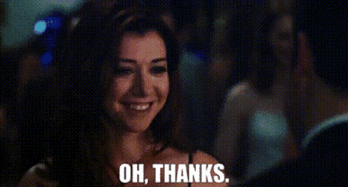 a woman is smiling and saying " oh , thanks " .