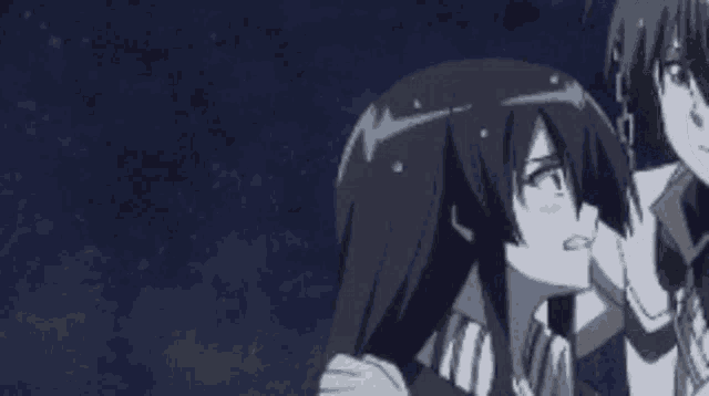 a man and a woman are standing next to each other in a dark room