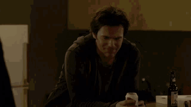 a man sitting at a table with the words snap out of what