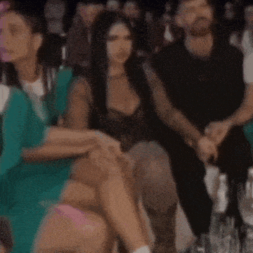 a blurry picture of a crowd of people clapping