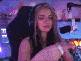 a woman wearing headphones is sitting in front of a microphone in a room .