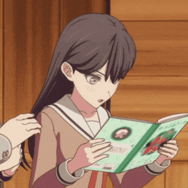 a girl in a school uniform is reading a book with a picture of a cat on the cover
