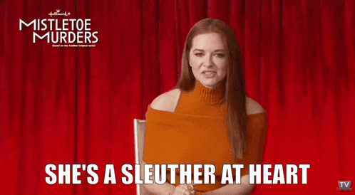 a woman is standing in front of a red curtain and says she 's a sleuther at heart