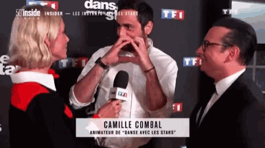 a man is being interviewed by a woman with camille combal at the bottom