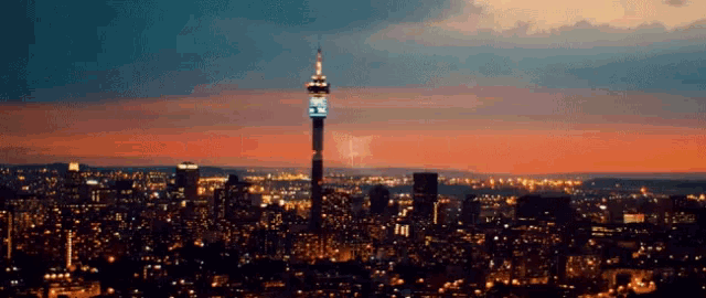 a very tall tower in the middle of a city at night