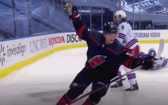 a hockey game is being played in front of a honda ad