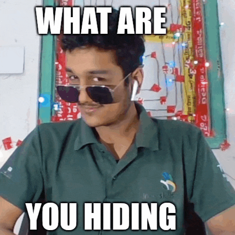 a man wearing sunglasses and a green shirt with the words what are you hiding written on it