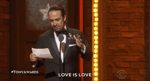 a man in a tuxedo is giving a speech at a tony awards ceremony .