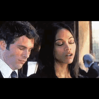 a man and a woman are standing next to each other