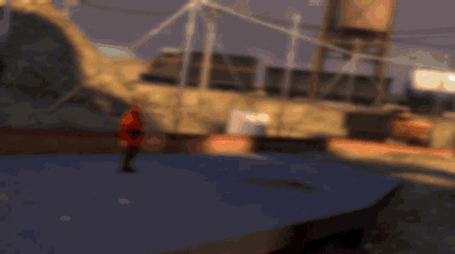 a man in a red jacket is holding a pair of guns