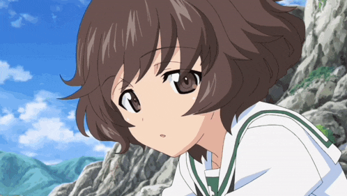 a close up of a girl with brown hair and a white shirt