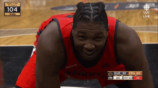 a basketball player wearing a red jersey with the word bandit on the front