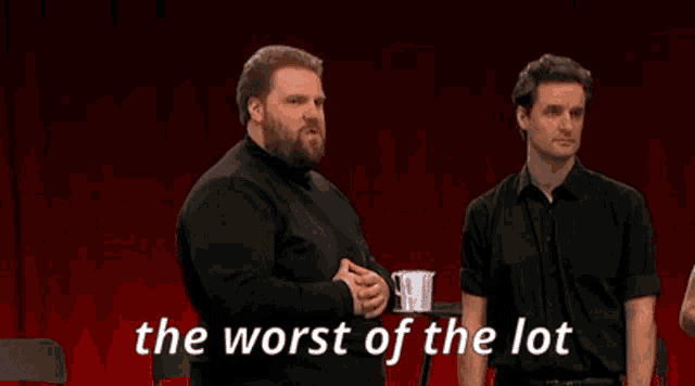 two men are standing in front of a red curtain with the words " the worst of the lot "