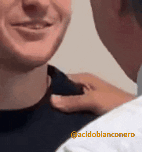 a man putting his hand on another man 's neck with the hashtag acidobianconero on the bottom