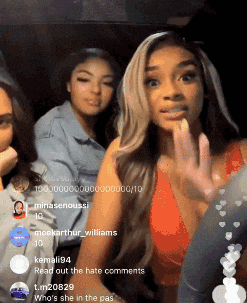 three women are sitting in a car and one of them is wearing a red tank top