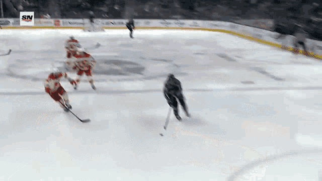 a hockey game is being played on a ice rink with an advertisement for vector security