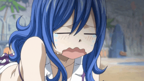 a girl with blue hair making a funny face with her eyes closed