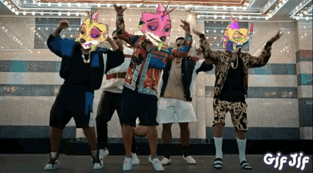 a group of men are dancing in front of a sign that says gif jf