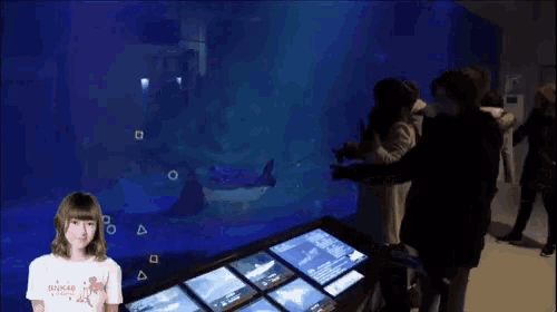 a woman stands in front of a screen that says ' uonnssuon ' on it