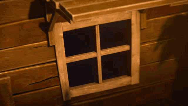 a wooden window in a wooden wall
