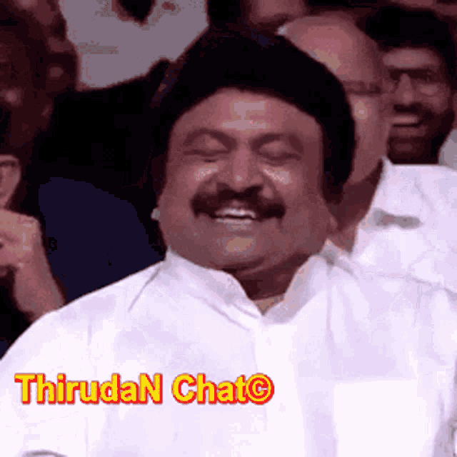 a man with a mustache is smiling in front of a crowd with the words thirudan chat written on the bottom