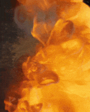 a close up of a fire with the word coca cola on it