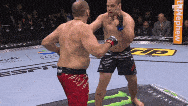 two men are fighting in a boxing ring with a monster energy drink in the foreground