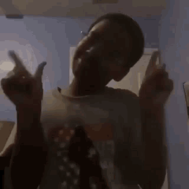 a young man is flexing his muscles in front of a mirror in a room .
