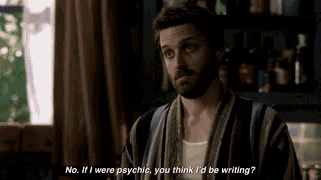 a man with a beard is wearing a robe and talking to another man .