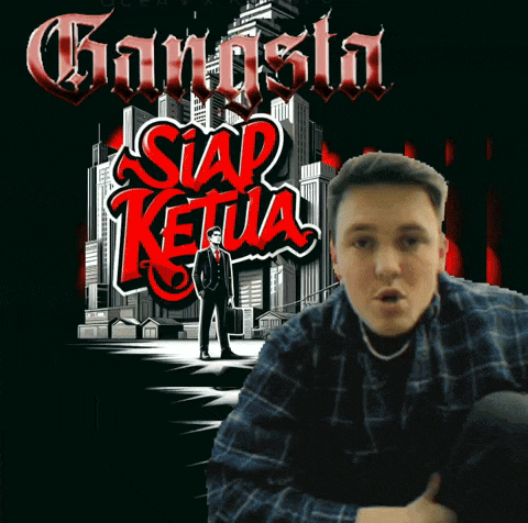 a man is sitting in front of a poster that says gangster siap ketua