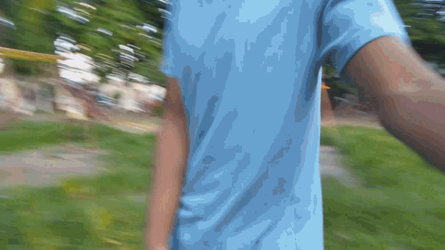 a blurry picture of a person wearing a blue t-shirt