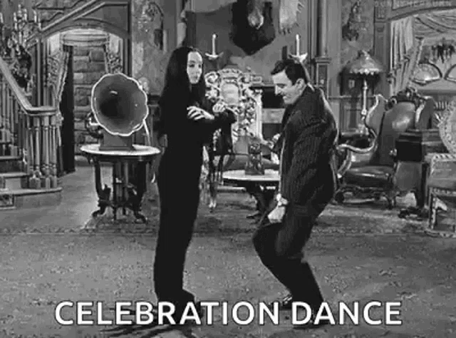 a man and a woman are dancing together in a living room .