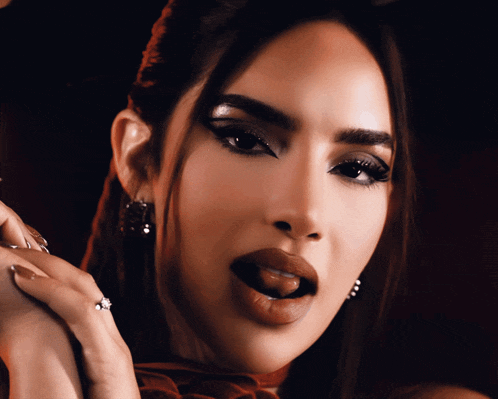 a close up of a woman with her tongue out