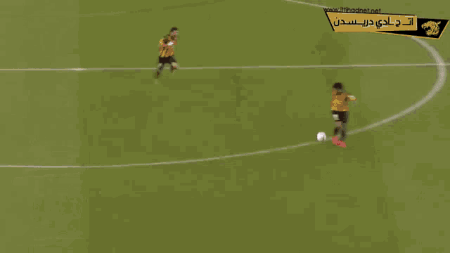 a soccer game is being played on a field with a yellow banner that says www.allianz.com