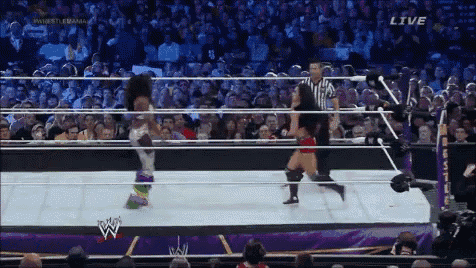 two women are wrestling in a wrestling ring with the word live on the screen
