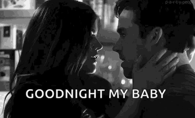 a man and a woman are kissing in a black and white photo with the words `` goodnight my baby '' .