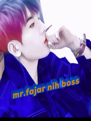 a man with purple hair is wearing a blue shirt with the words mr.fajar nih boss on it