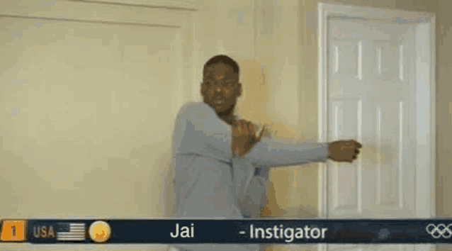 a man is stretching his arms in a room in front of a door .