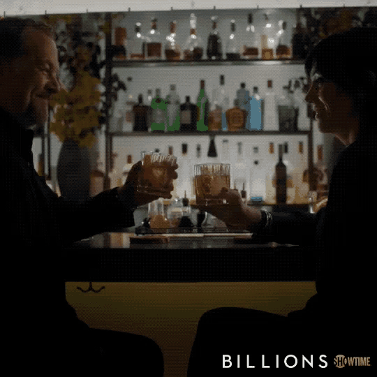 a man and woman toasting at a bar with the words billions showtime on the bottom