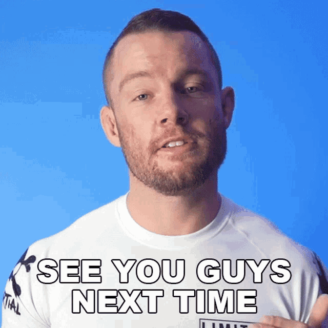 a man with a beard wearing a white shirt that says see you guys next time