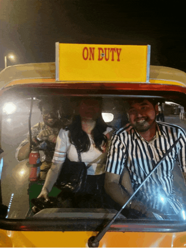 a yellow sign that says on duty on top of a yellow vehicle