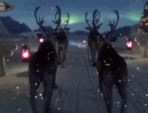 two reindeer are walking down a snowy street with lanterns in the background