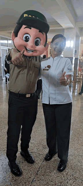 a woman giving a thumbs up next to a man in a mascot outfit