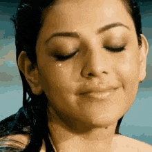 a close up of a woman 's face with water coming out of her eyes