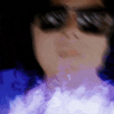 a close up of a person 's face with sunglasses on
