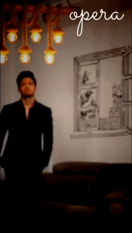 a blurry picture of a man standing in front of a window with the word opera on the bottom