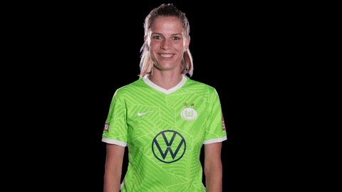 a woman wearing a green shirt with a vw logo on the front