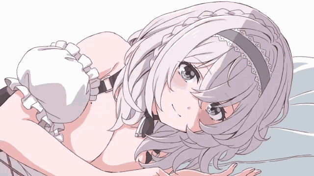 a girl with white hair and green eyes is laying down on a bed