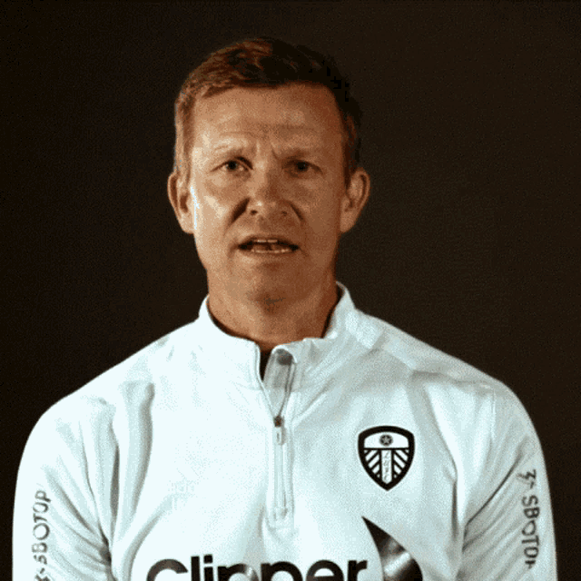 a man wearing a white shirt with the word clipper on the front